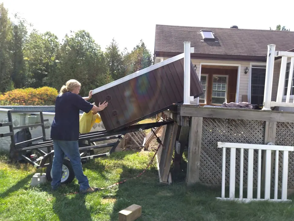 Hot tub being moved into position on a raised deck