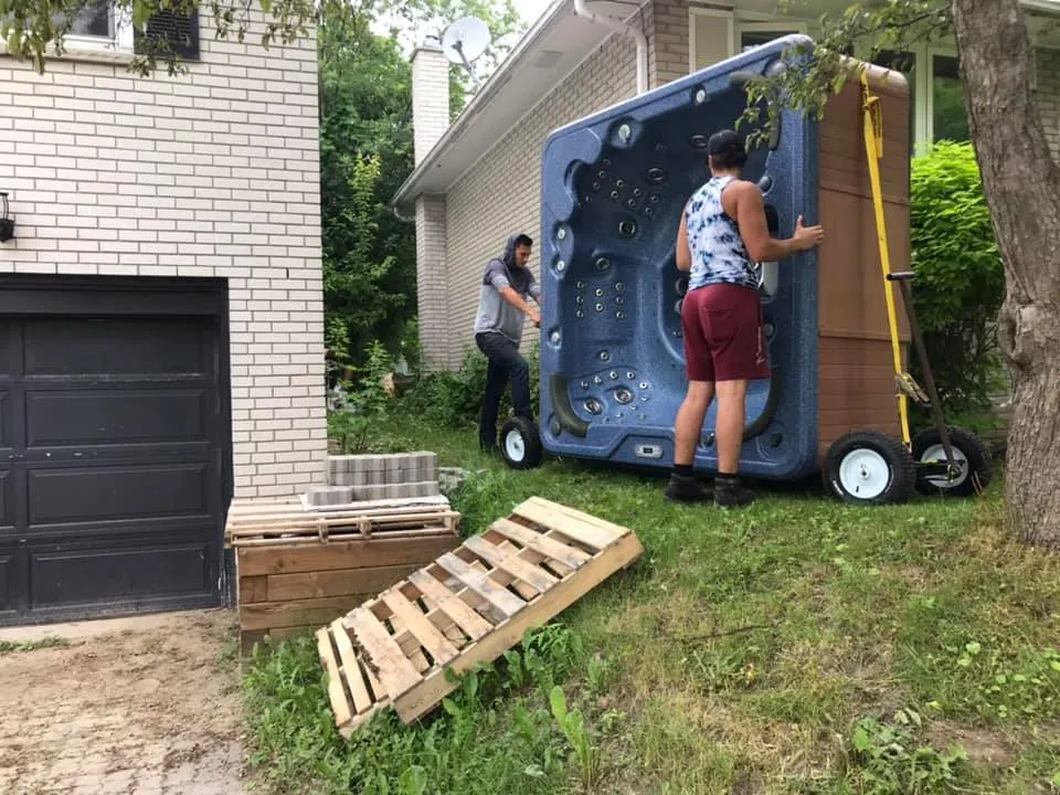 Hot tub being moved through tight backyard access