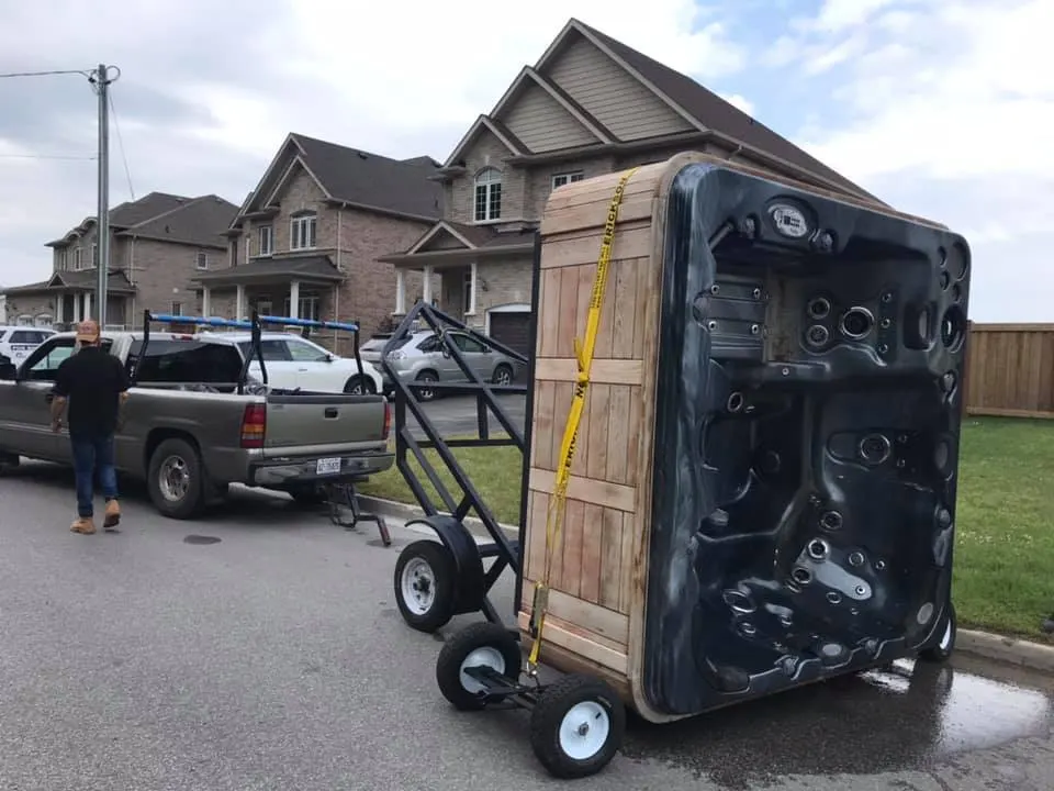 Hot tub moved vertically on equipment in a driveway