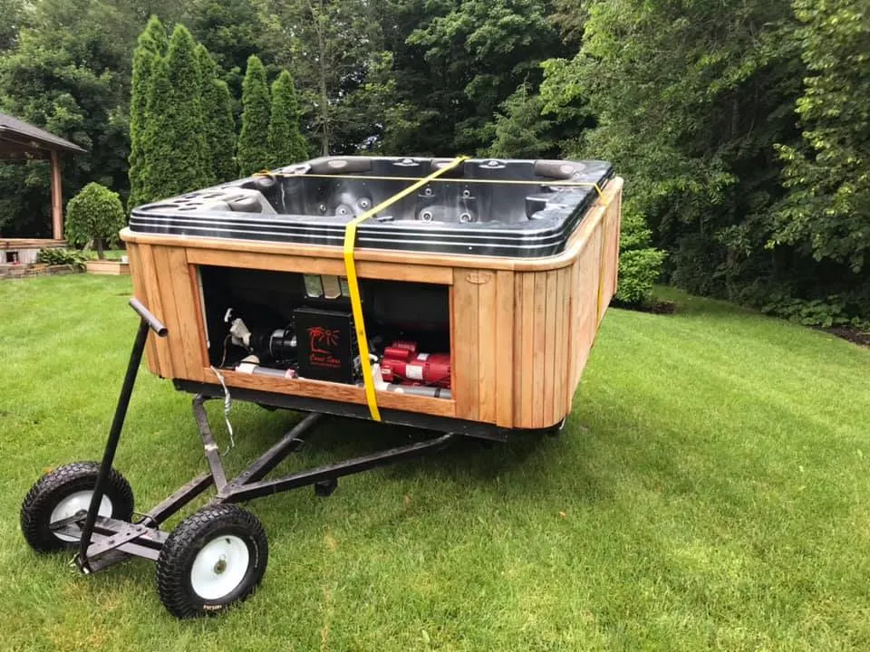 Hot tub on a small trailer in a backyard