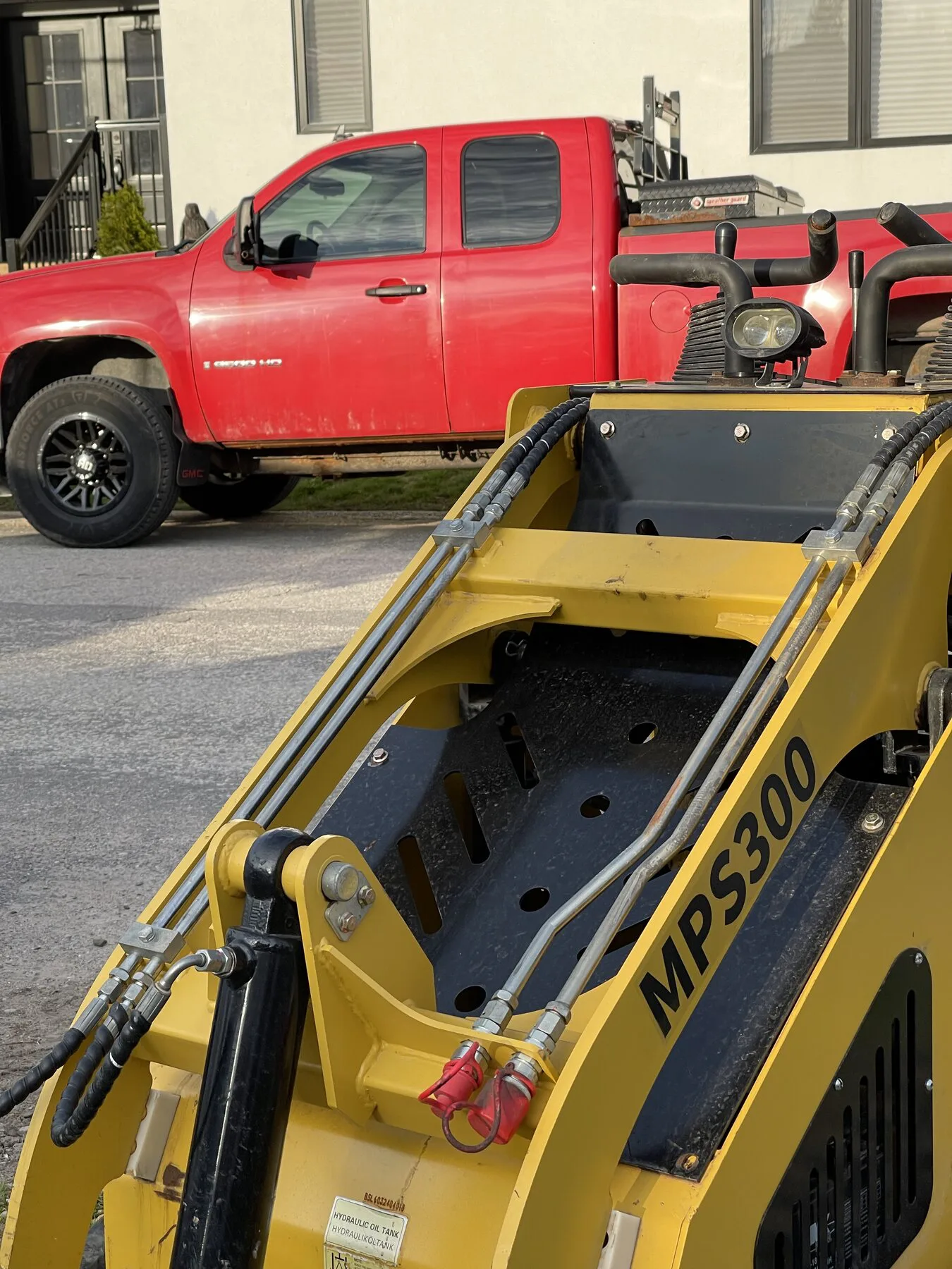 Sunshine work truck and hot tub moving equipment staged on a driveway